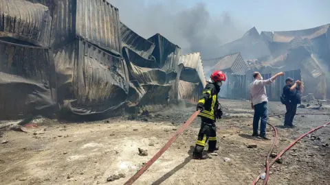 AFP Firemen try to extinguish fires at Shahid Rajaee port in Bandar Abbas, Iran (28 April 2025)